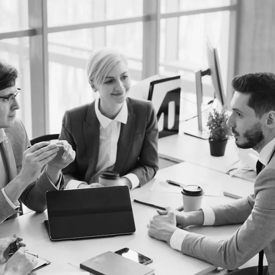 A business team collaborating around a table in a working session
